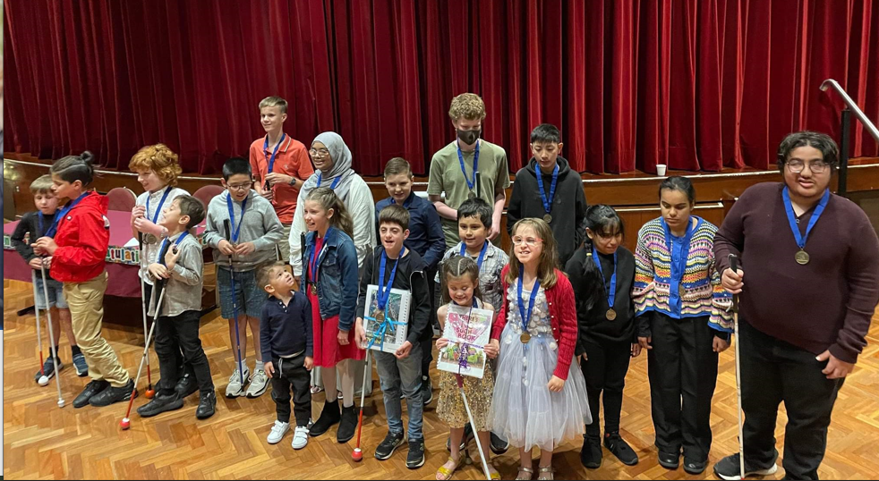 A photograph of the students with their award medals.