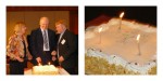 Mary Schnackenberg, Bruce Maguire and Brian Conway cutting a cake decorated with birthday candles and a braille message written with sugar pearls.
