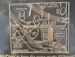 Bronze sign with raised lines for roads and sports stadiums